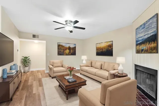 a living room with furniture a flat screen tv and a couch