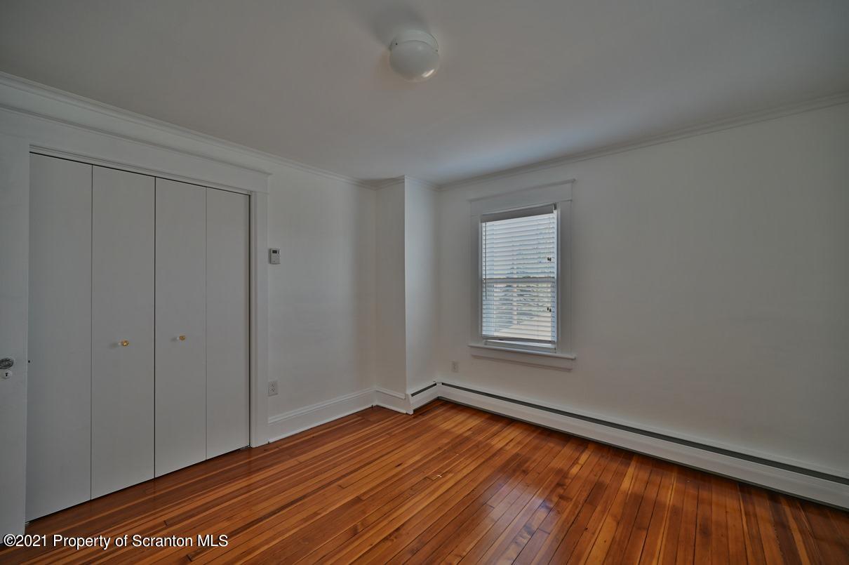 1909 Green Ridge Street Dunmore, PA 18512 - Photo 40 of 50 a view of an empty room with wooden floor and a window