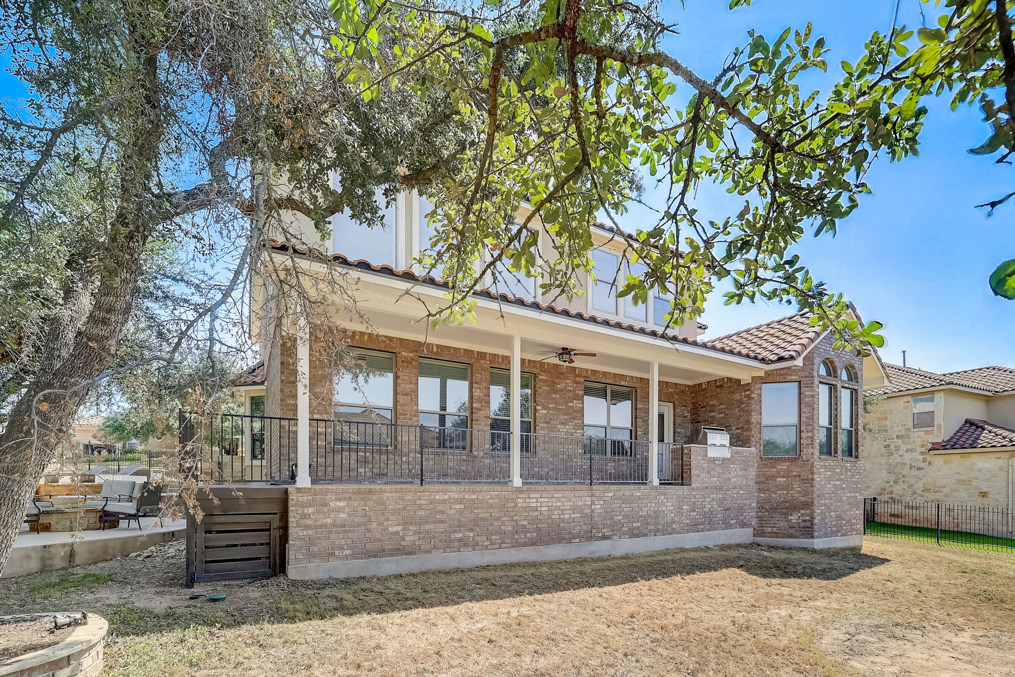 16012 Spillman Ranch Loop Austin, TX 78738 - Photo 35 of 38 A spacious outdoor living area with a covered patio offers ample space for entertaining and relaxation.