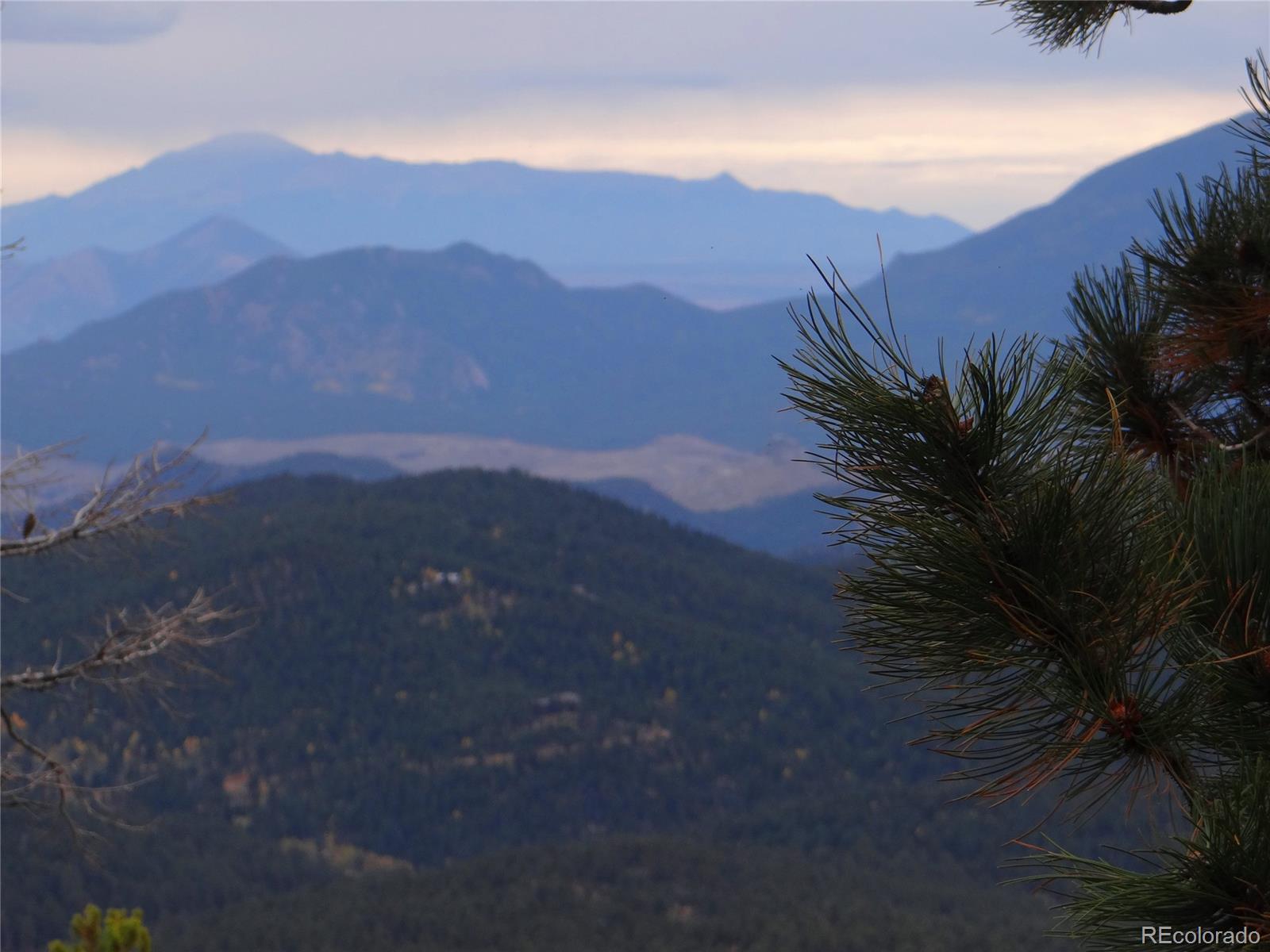 11760 Baca Road Conifer, CO 80433 - Photo 17 of 24 a view of a house with a mountain