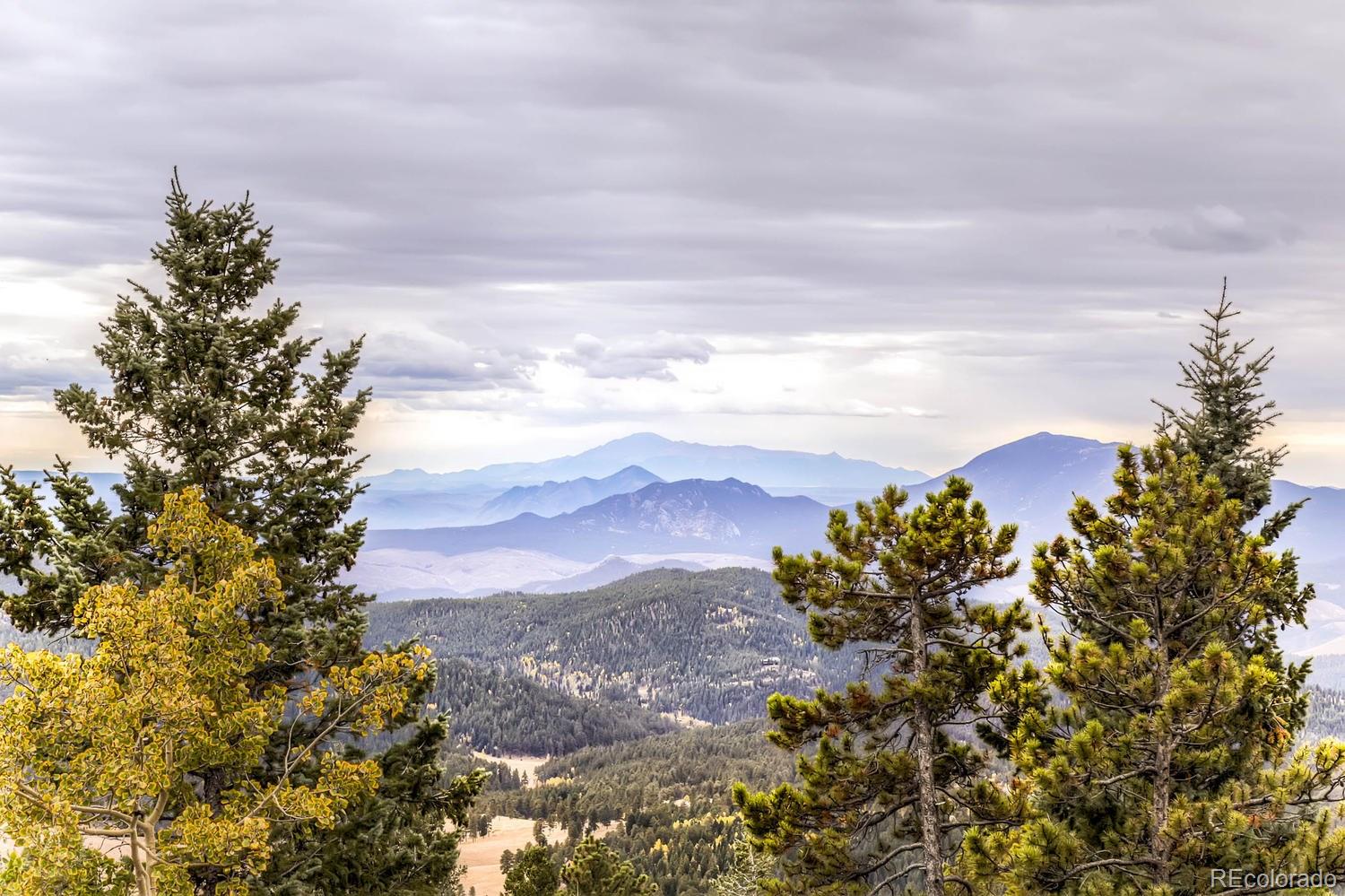 11760 Baca Road Conifer, CO 80433 - Photo 2 of 24 a sunset view with mountains in the background