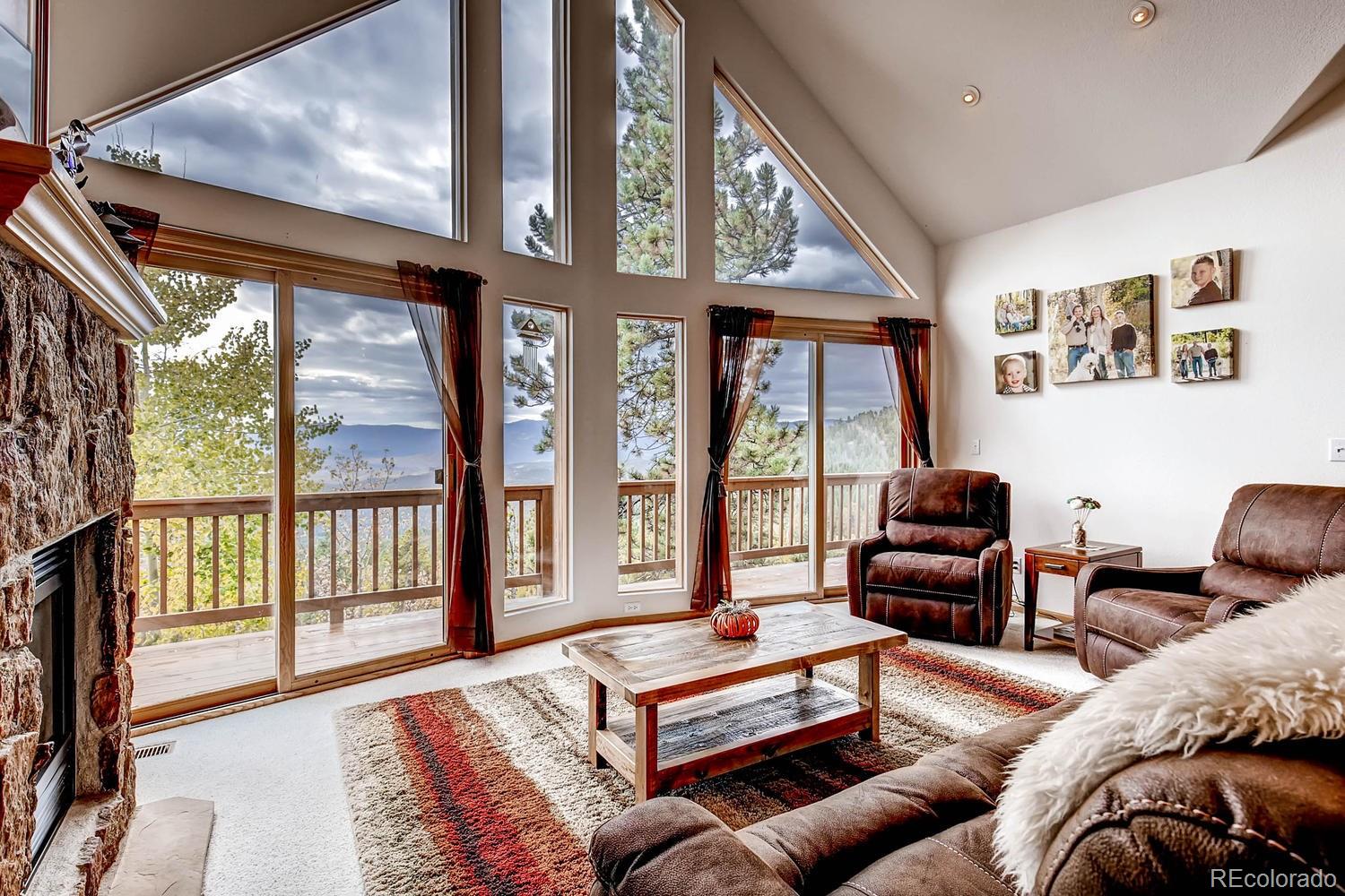 11760 Baca Road Conifer, CO 80433 - Photo 3 of 24 a living room with furniture a large window