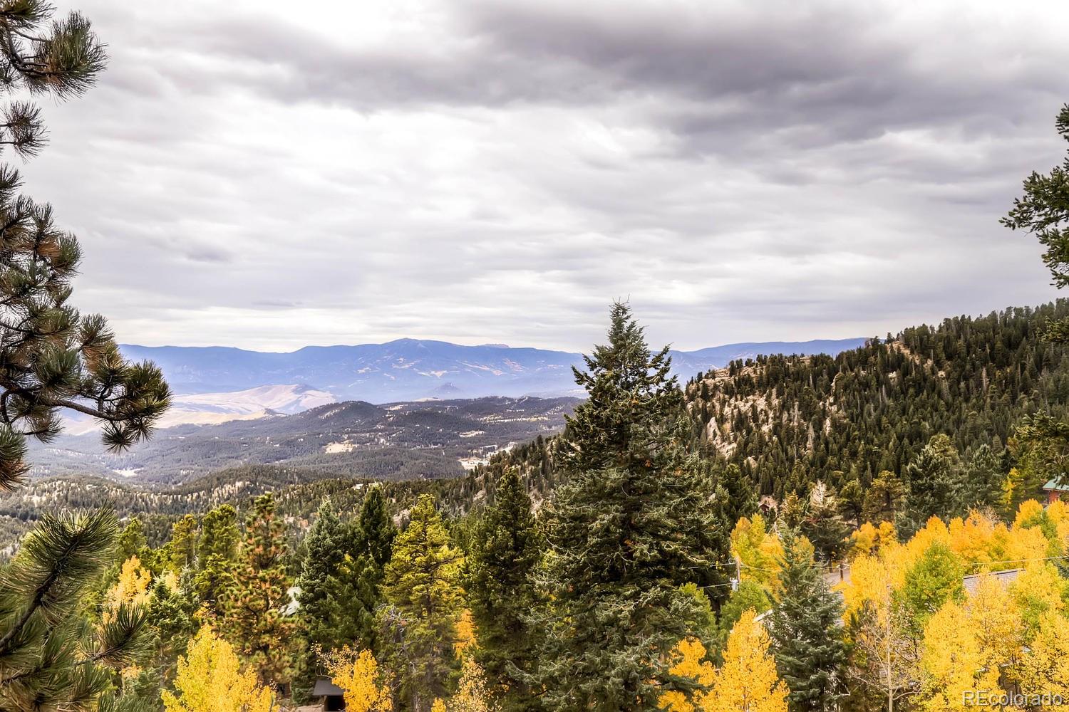 11760 Baca Road Conifer, CO 80433 - Photo 7 of 24 a view of a city with mountains in the background