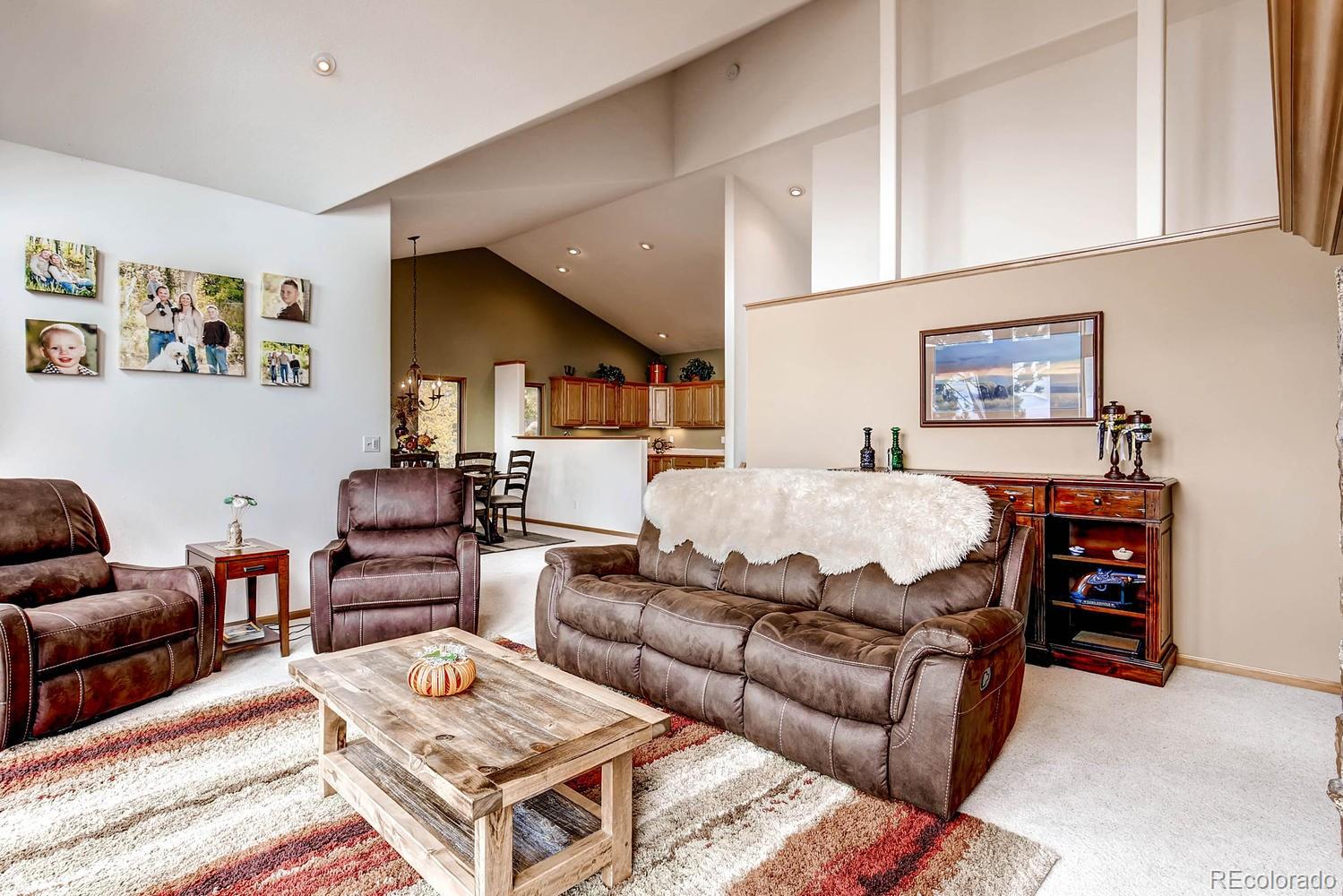 11760 Baca Road Conifer, CO 80433 - Photo 8 of 24 a living room with furniture a rug and a window