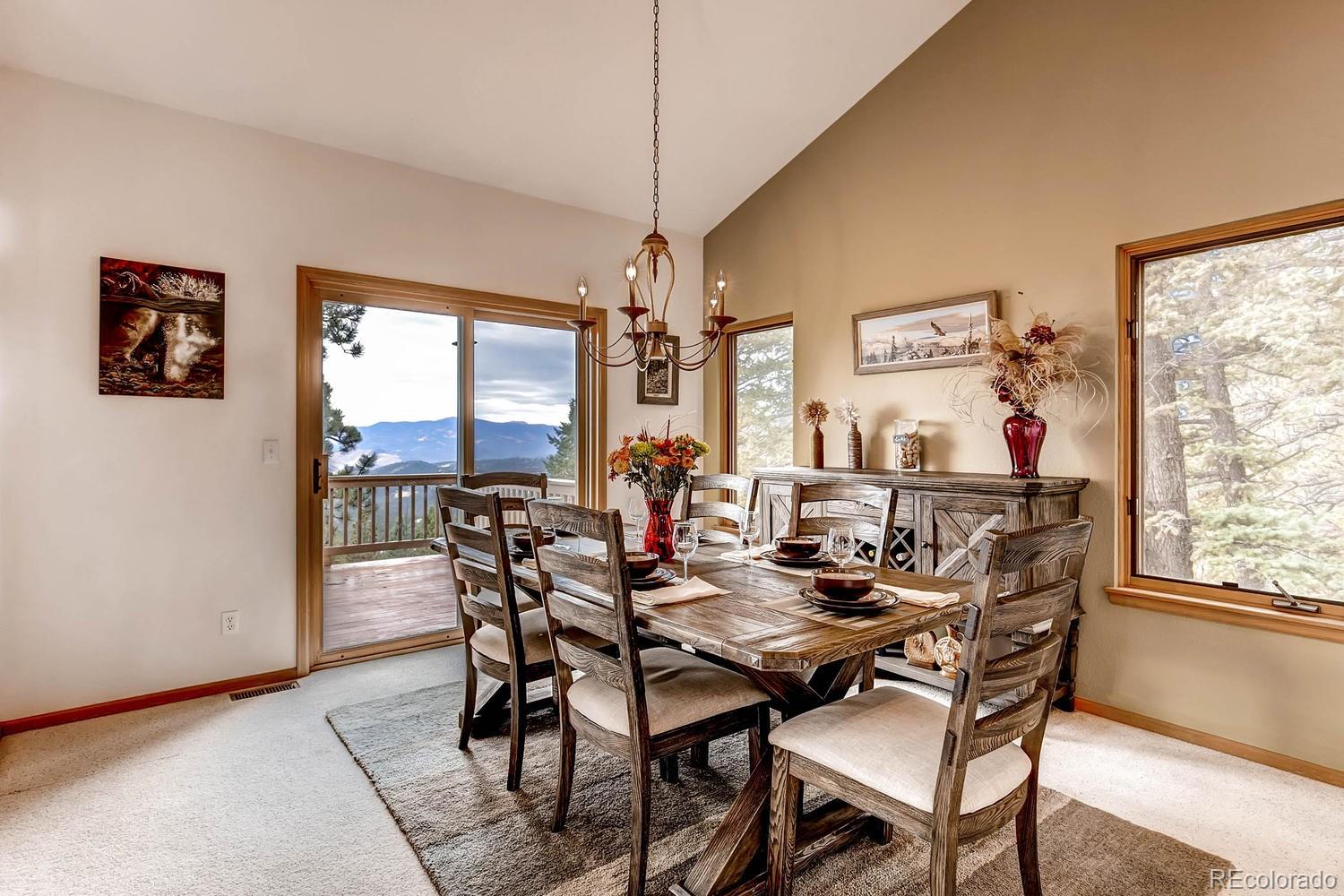 11760 Baca Road Conifer, CO 80433 - Photo 10 of 24 a view of a dining room with furniture window and outside view