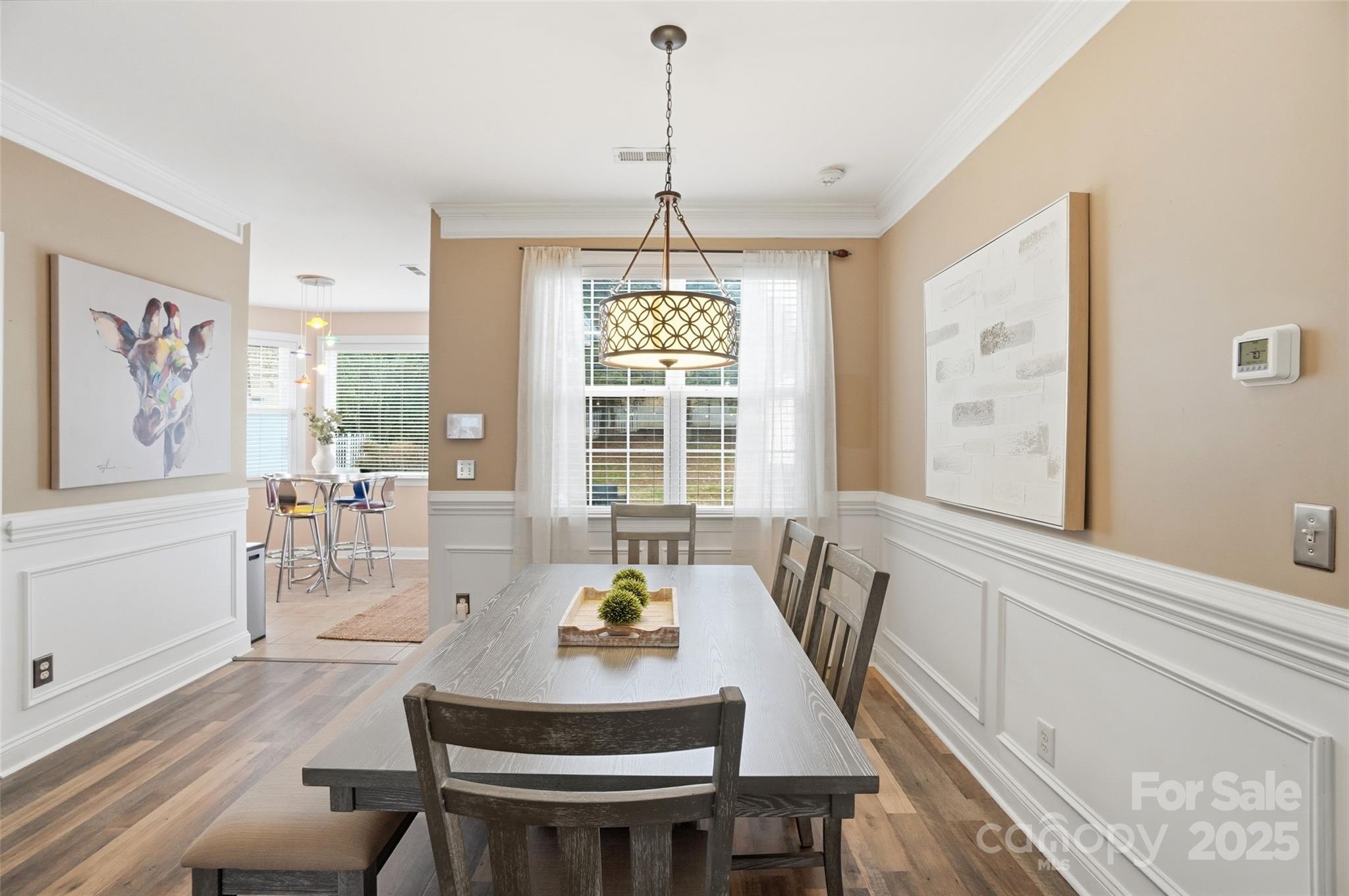 10432 Watoga Way Cornelius, NC 28031 - Photo 15 of 42 a dining room with furniture a chandelier and wooden floor