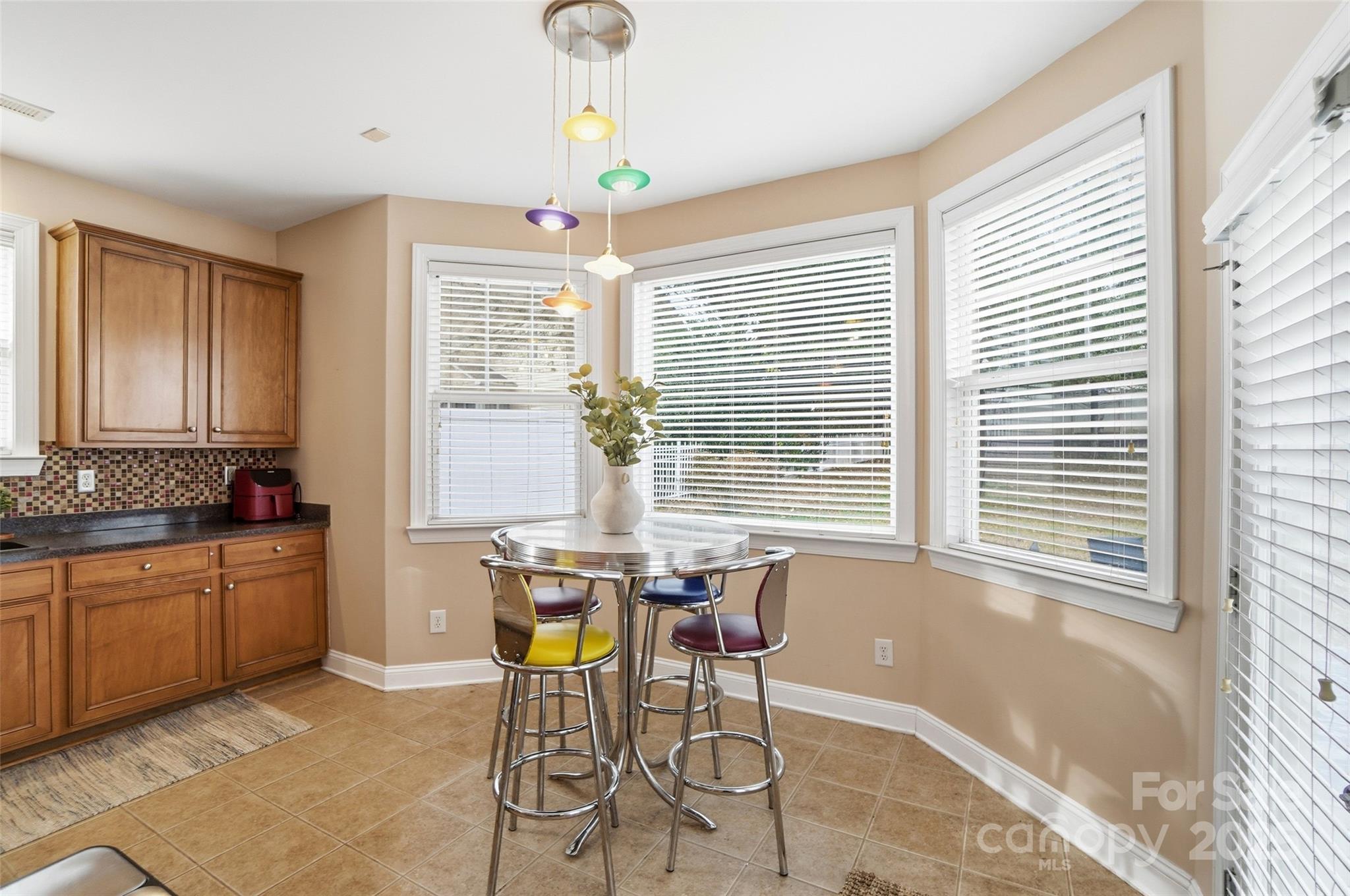 10432 Watoga Way Cornelius, NC 28031 - Photo 18 of 42 a view of a dining room with furniture windows and wooden floor