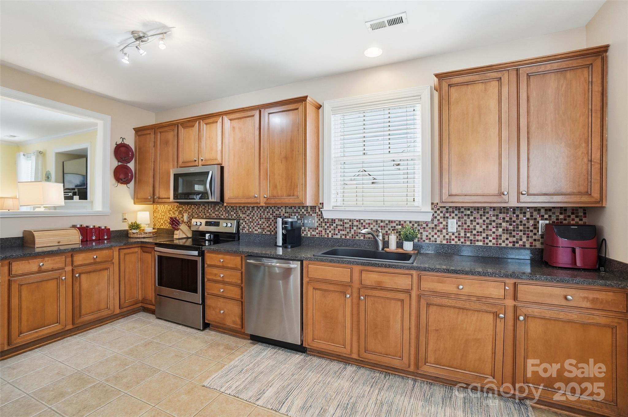 10432 Watoga Way Cornelius, NC 28031 - Photo 22 of 42 a kitchen with stainless steel appliances granite countertop a stove sink and cabinets