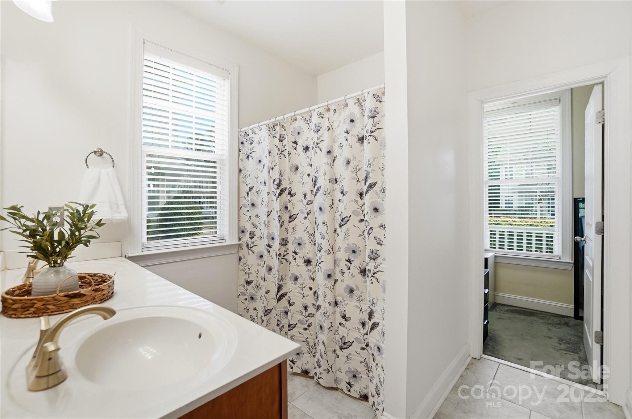10432 Watoga Way Cornelius, NC 28031 - Photo 27 of 42 a bathroom with a sink and a bathtub