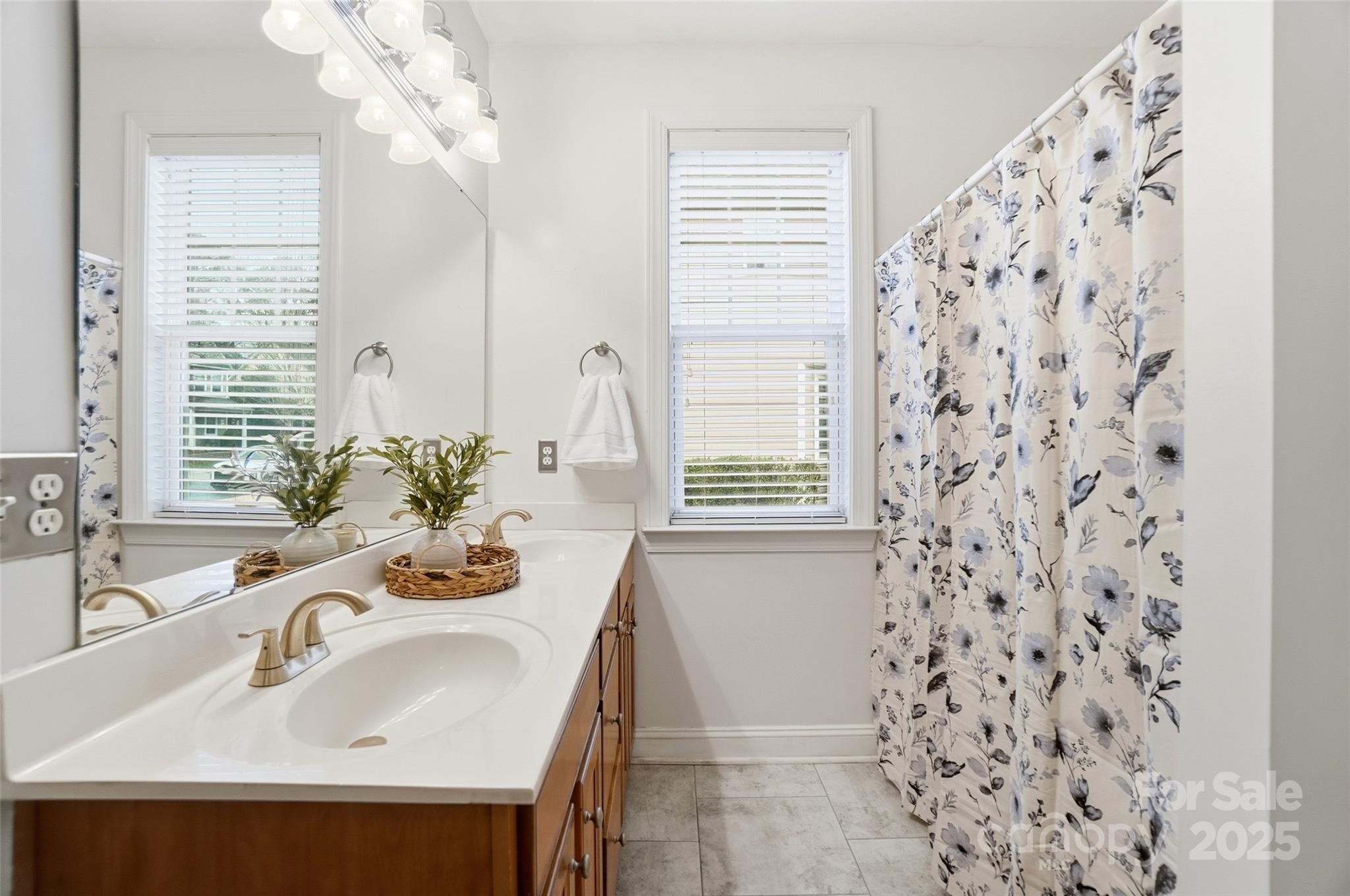 10432 Watoga Way Cornelius, NC 28031 - Photo 28 of 42 a bathroom with a sink a mirror and a window