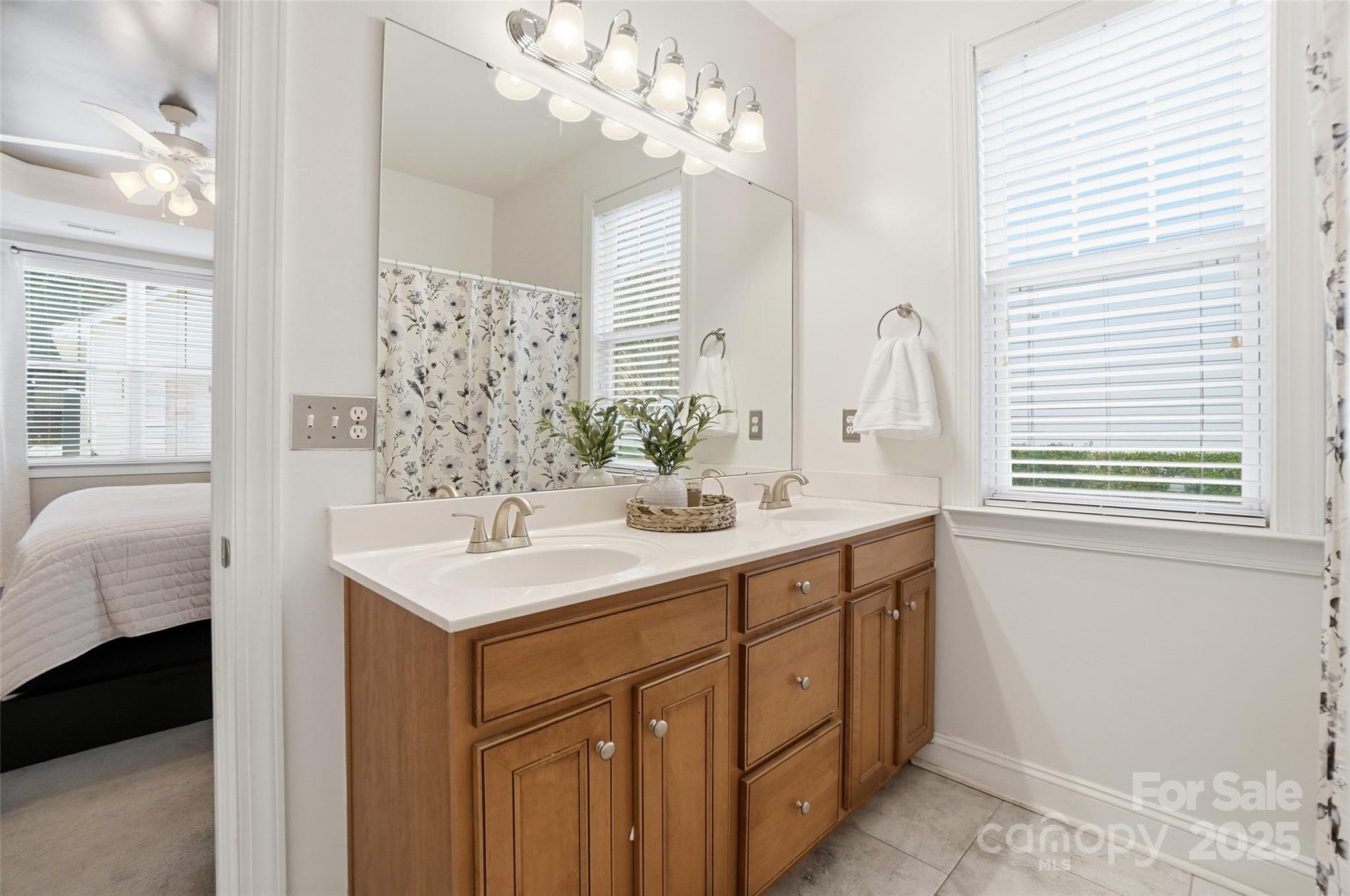 10432 Watoga Way Cornelius, NC 28031 - Photo 29 of 42 a bathroom with a sink vanity and a mirror