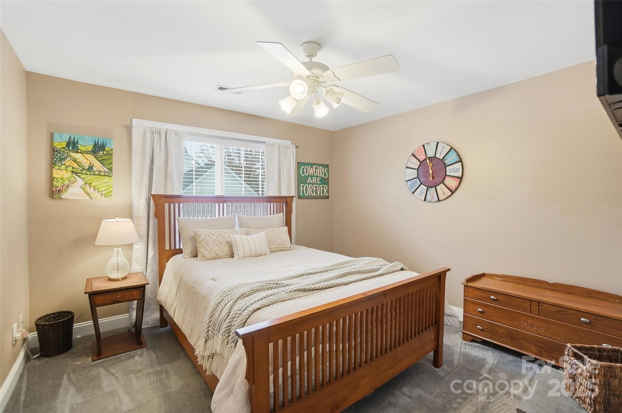 10432 Watoga Way Cornelius, NC 28031 - Photo 31 of 42 a bedroom with a bed and a chandelier