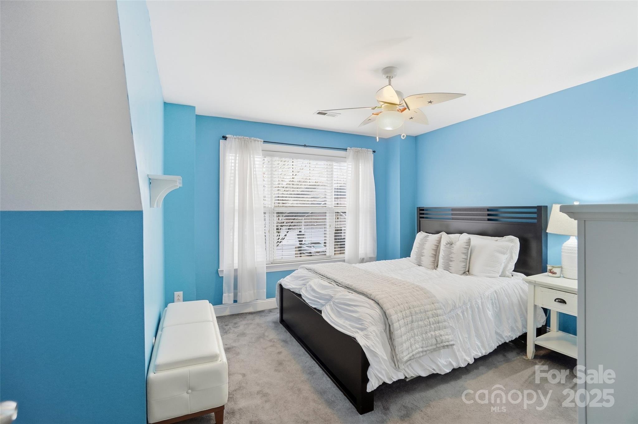 10432 Watoga Way Cornelius, NC 28031 - Photo 33 of 42 a bedroom with a bed couch chandelier and a window