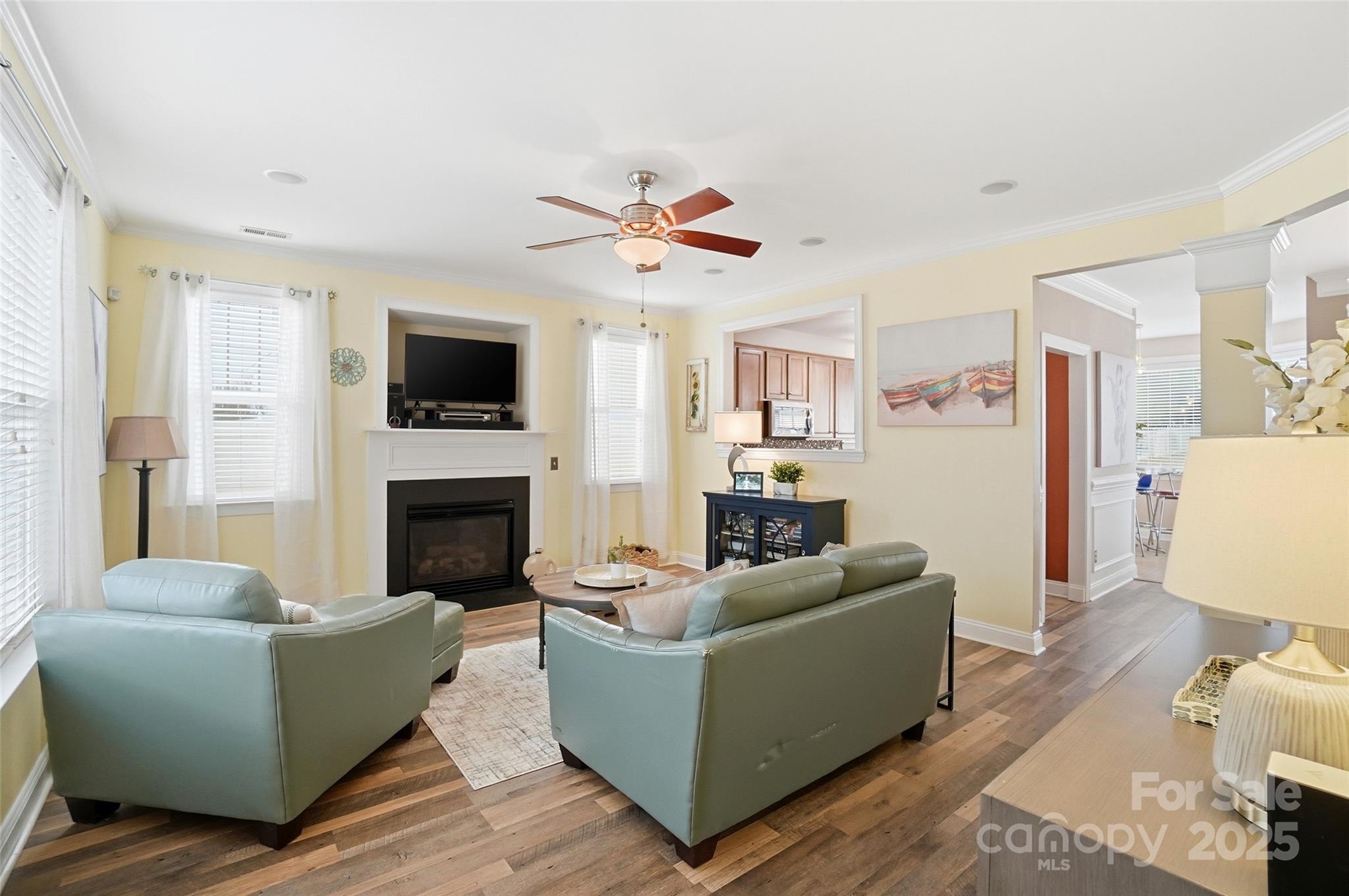 10432 Watoga Way Cornelius, NC 28031 - Photo 9 of 42 a living room with furniture a fireplace and a flat screen tv