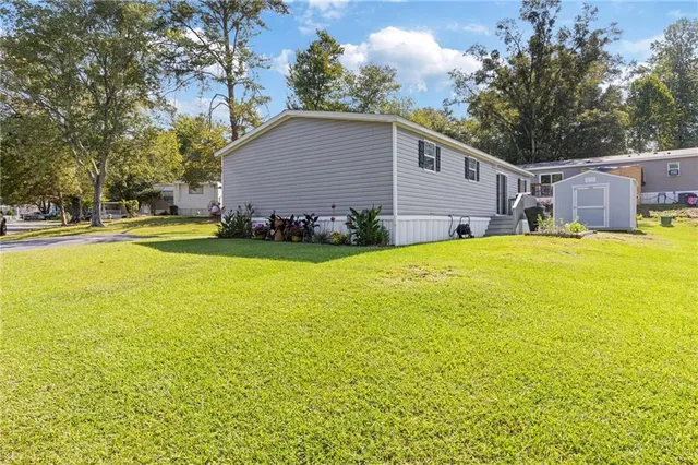 a view of a house with a yard and swimming pool