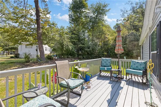 a view of deck with furniture and trees