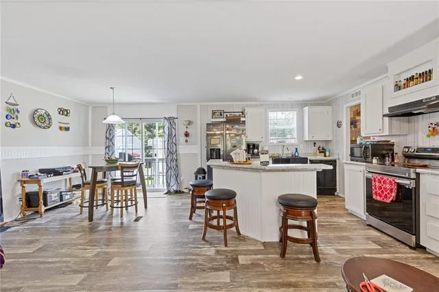 a living room with stainless steel appliances kitchen island granite countertop furniture and a kitchen view