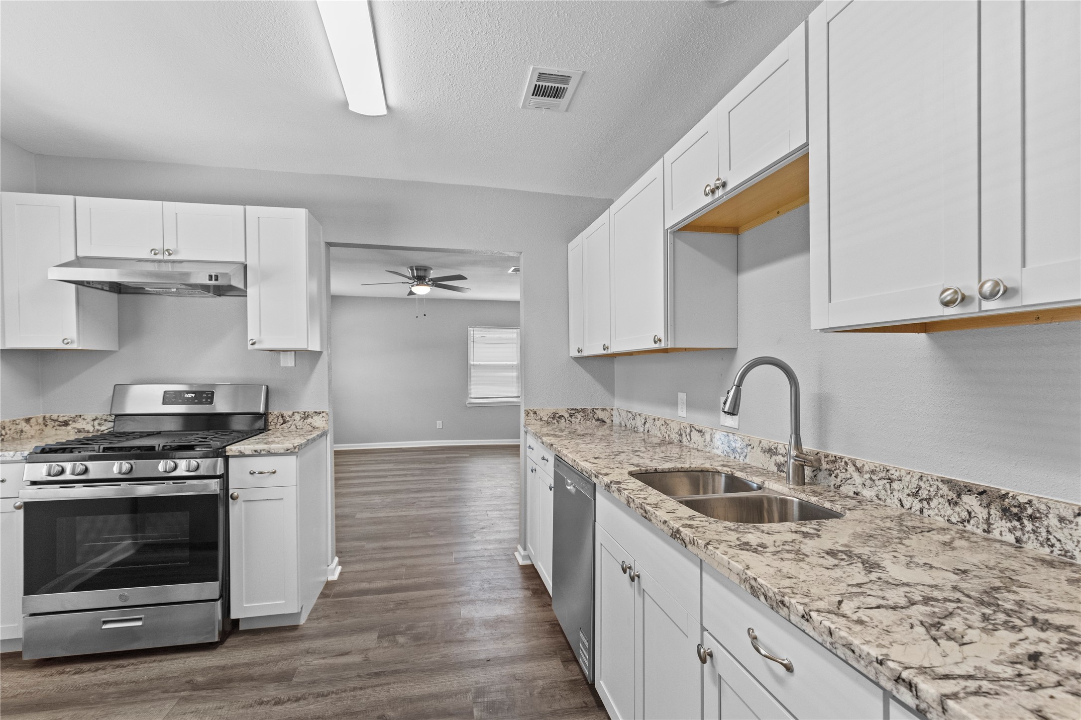 4838 Van Fleet Street Houston, TX 77033 - Photo 7 of 19 Alternate view of the kitchen seeing into the living room.