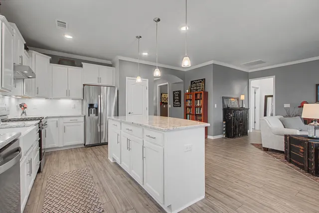 a view of a dining room with furniture a chandelier and wooden floor