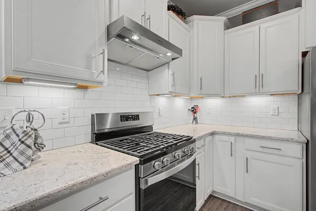 a dining room filled chandelier and kitchen view