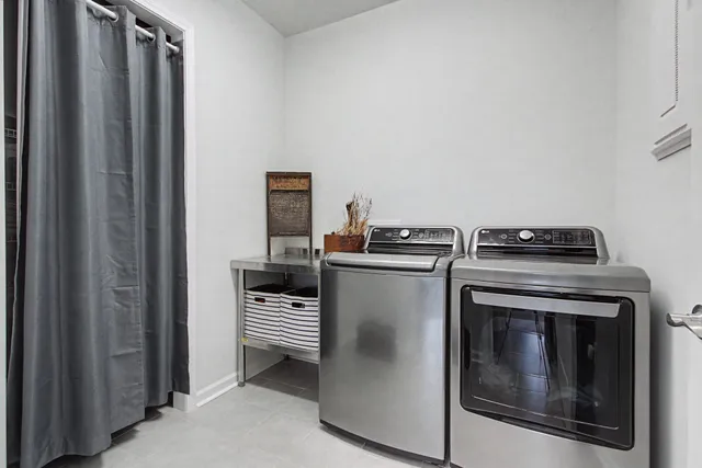a view of a roof deck with couches and wooden floor