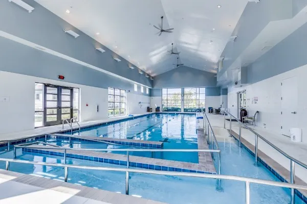 a view of swimming pool with outdoor seating and lake view