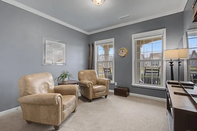 a large kitchen with kitchen island a sink a center island stainless steel appliances and a window