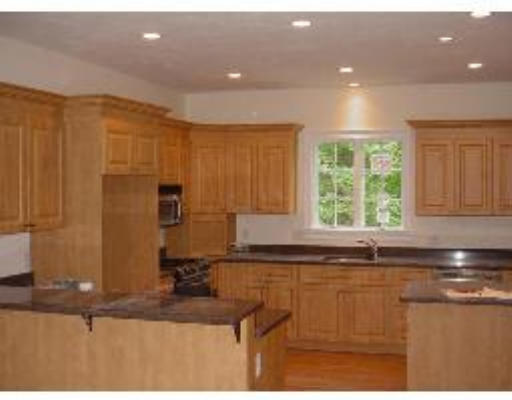 119 Westgate Road Waltham, MA 02453 - Photo 3 of 9 a kitchen with kitchen island granite countertop a sink window and cabinets