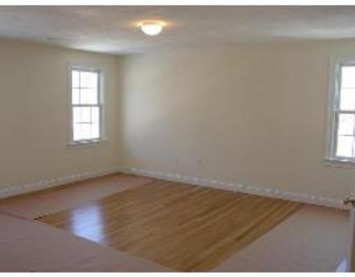 119 Westgate Road Waltham, MA 02453 - Photo 7 of 9 an empty room with wooden floor and windows