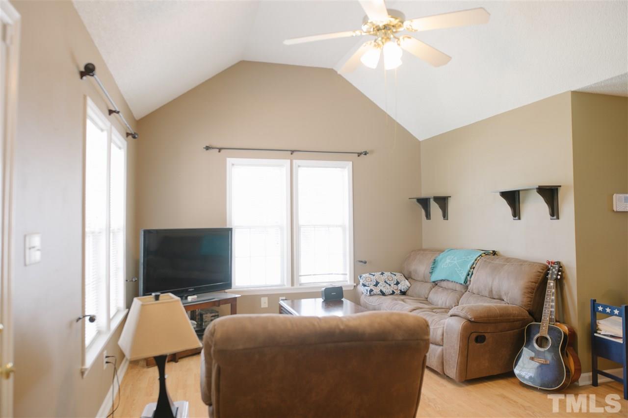 7244 Turner Fish Road Willow Spring, NC 27592 - Photo 4 of 18 a living room with furniture and a flat screen tv