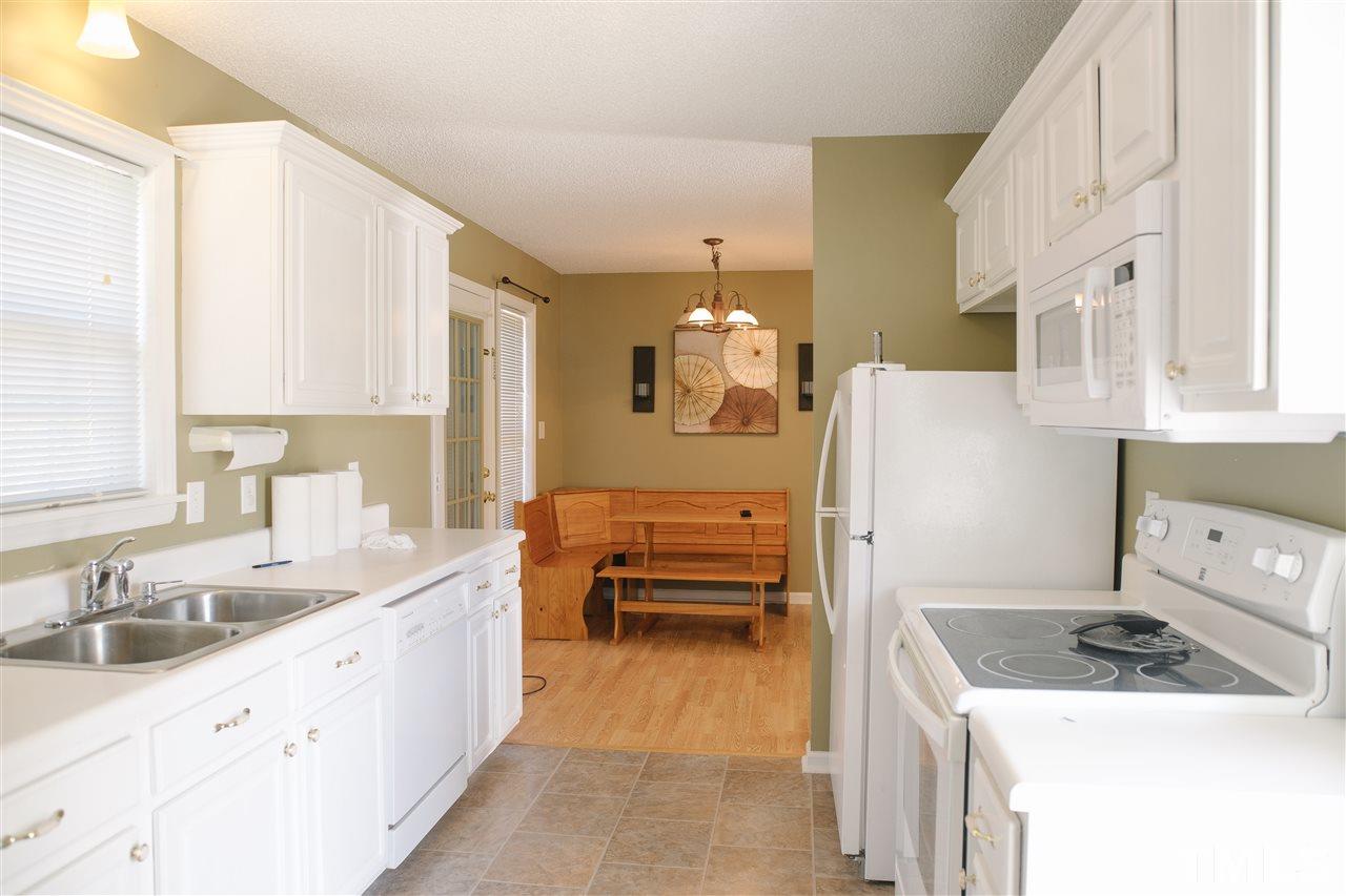 7244 Turner Fish Road Willow Spring, NC 27592 - Photo 5 of 18 a kitchen with a sink a stove and cabinets