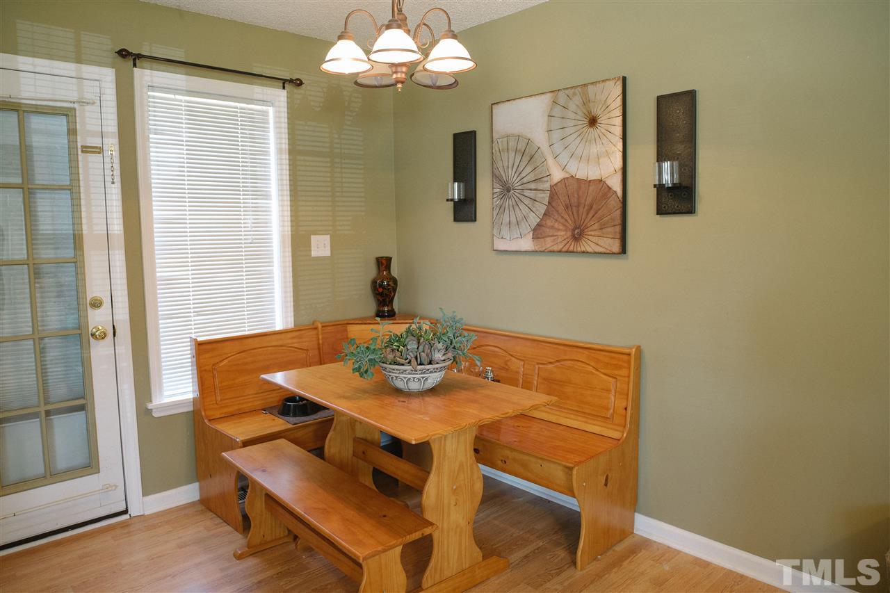7244 Turner Fish Road Willow Spring, NC 27592 - Photo 7 of 18 a view of a dining room with furniture and chandelier