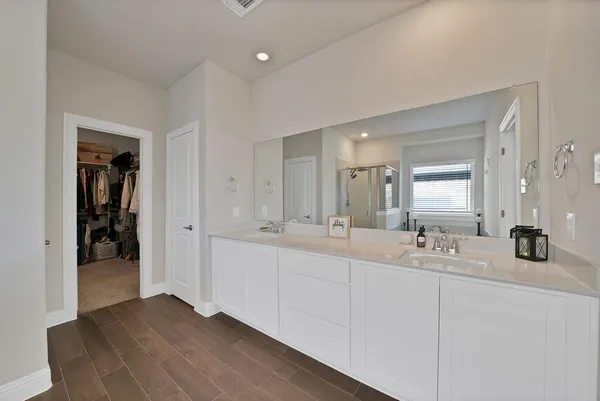 a bathroom with double vanity sinks and a mirror