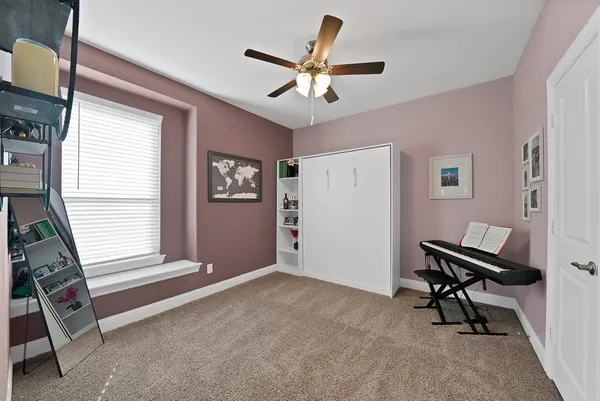 a view of workspace with window and ceiling fan