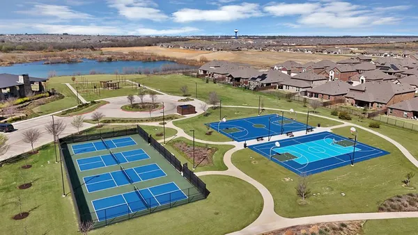 an aerial view of residential houses with outdoor space