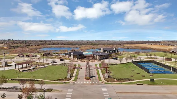 an aerial view of a house with a garden and lake view