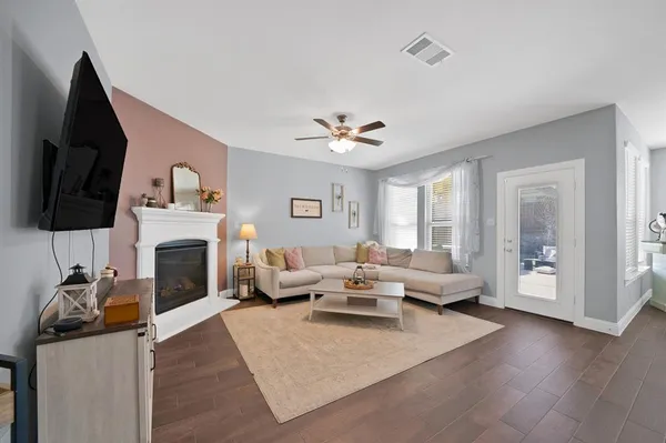 a living room with furniture fireplace and flat screen tv
