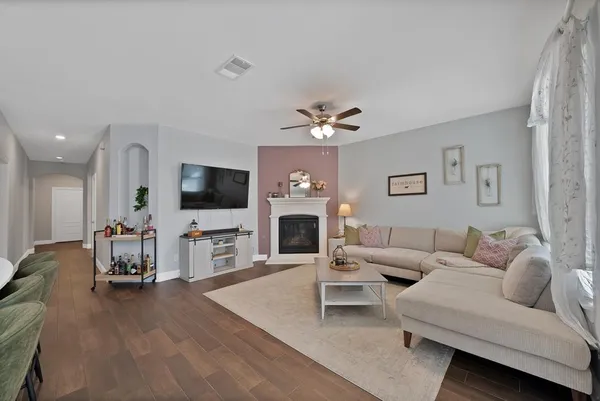 a living room with furniture a flat screen tv and a fireplace