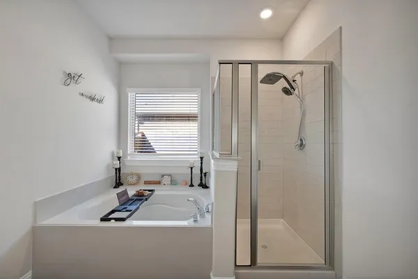 a bathroom with a sink a window and shower