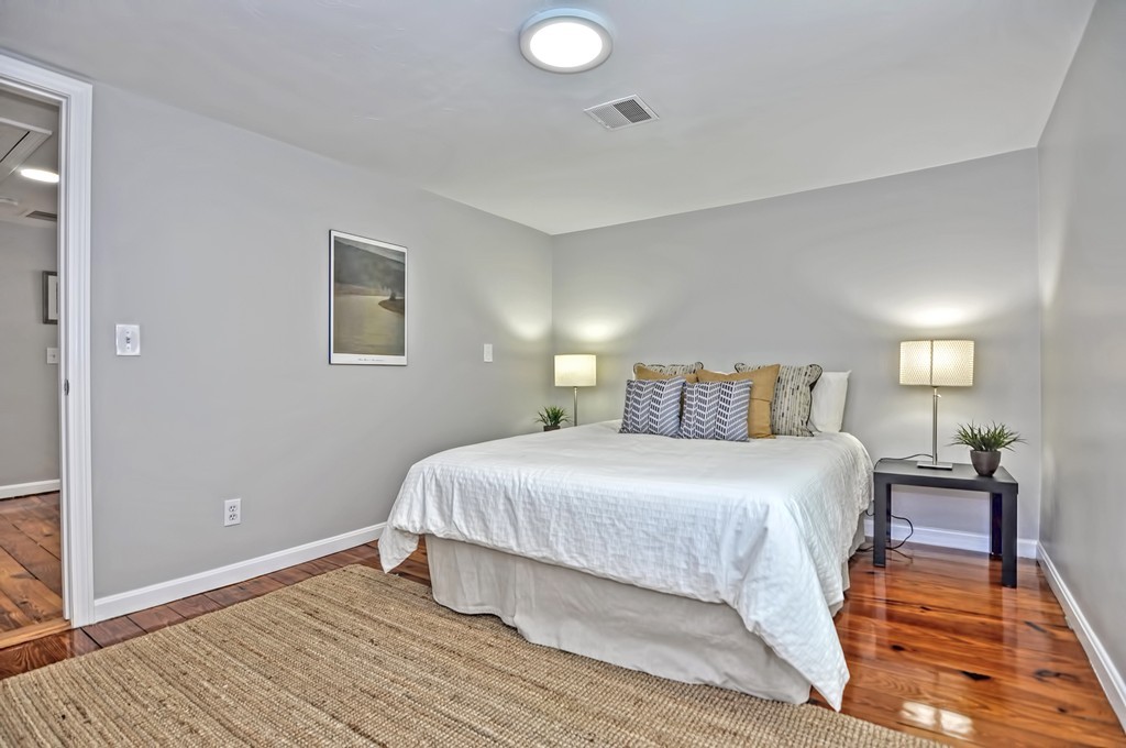 65 Edgewater Avenue Shrewsbury, MA 01545 - Photo 14 of 24 a bedroom with a bed and wooden floor