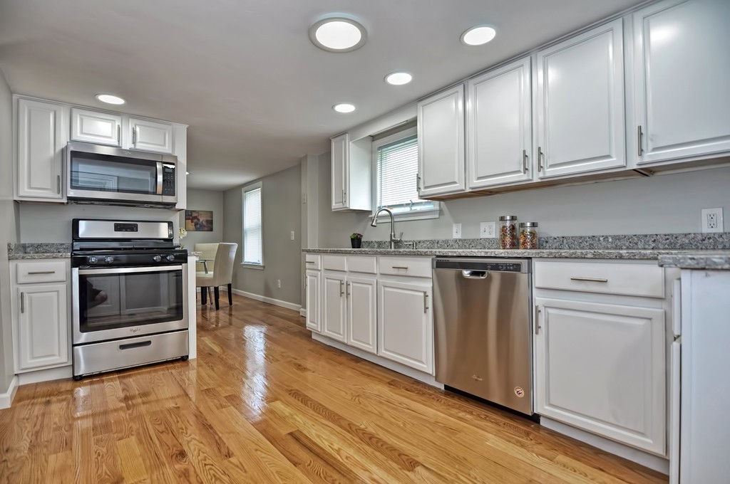 65 Edgewater Avenue Shrewsbury, MA 01545 - Photo 4 of 24 a kitchen with granite countertop a sink cabinets and stainless steel appliances