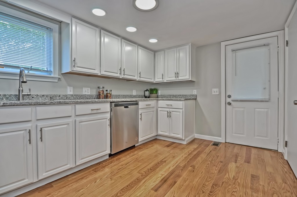 65 Edgewater Avenue Shrewsbury, MA 01545 - Photo 5 of 24 a kitchen with a sink cabinets and wooden floor