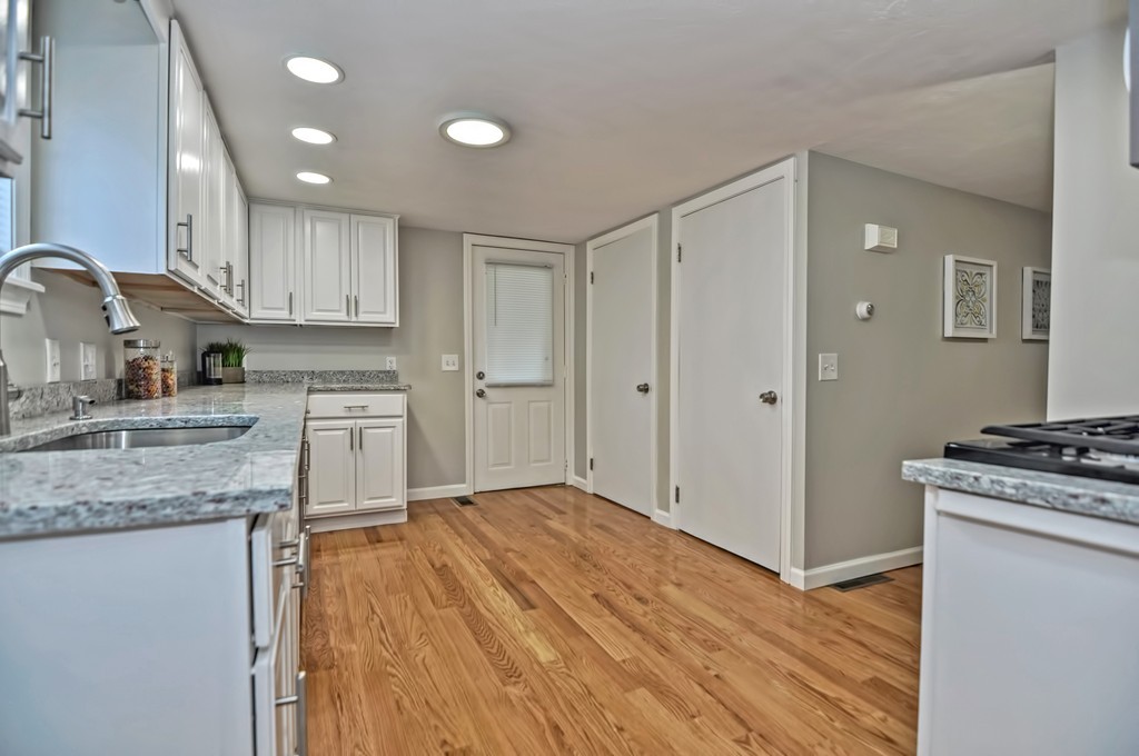 65 Edgewater Avenue Shrewsbury, MA 01545 - Photo 6 of 24 a kitchen with granite countertop a sink cabinets and stainless steel appliances