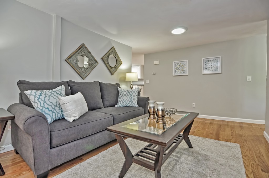 65 Edgewater Avenue Shrewsbury, MA 01545 - Photo 9 of 24 a living room with furniture and a wooden floor
