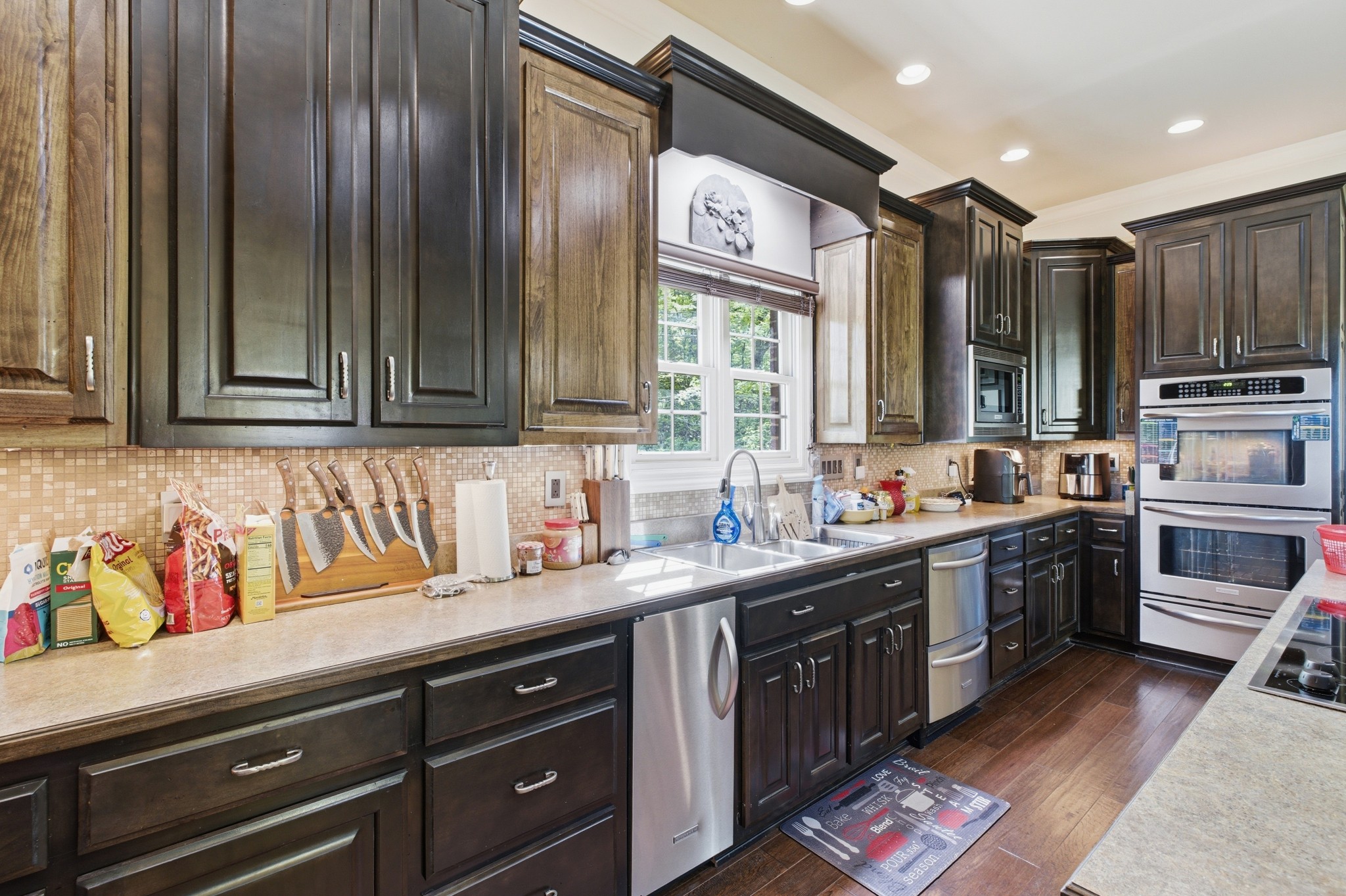 1605 Puryears Bend Road Hartsville, TN 37074 - Photo 25 of 63 a kitchen with stainless steel appliances granite countertop a sink wooden cabinets and a stove