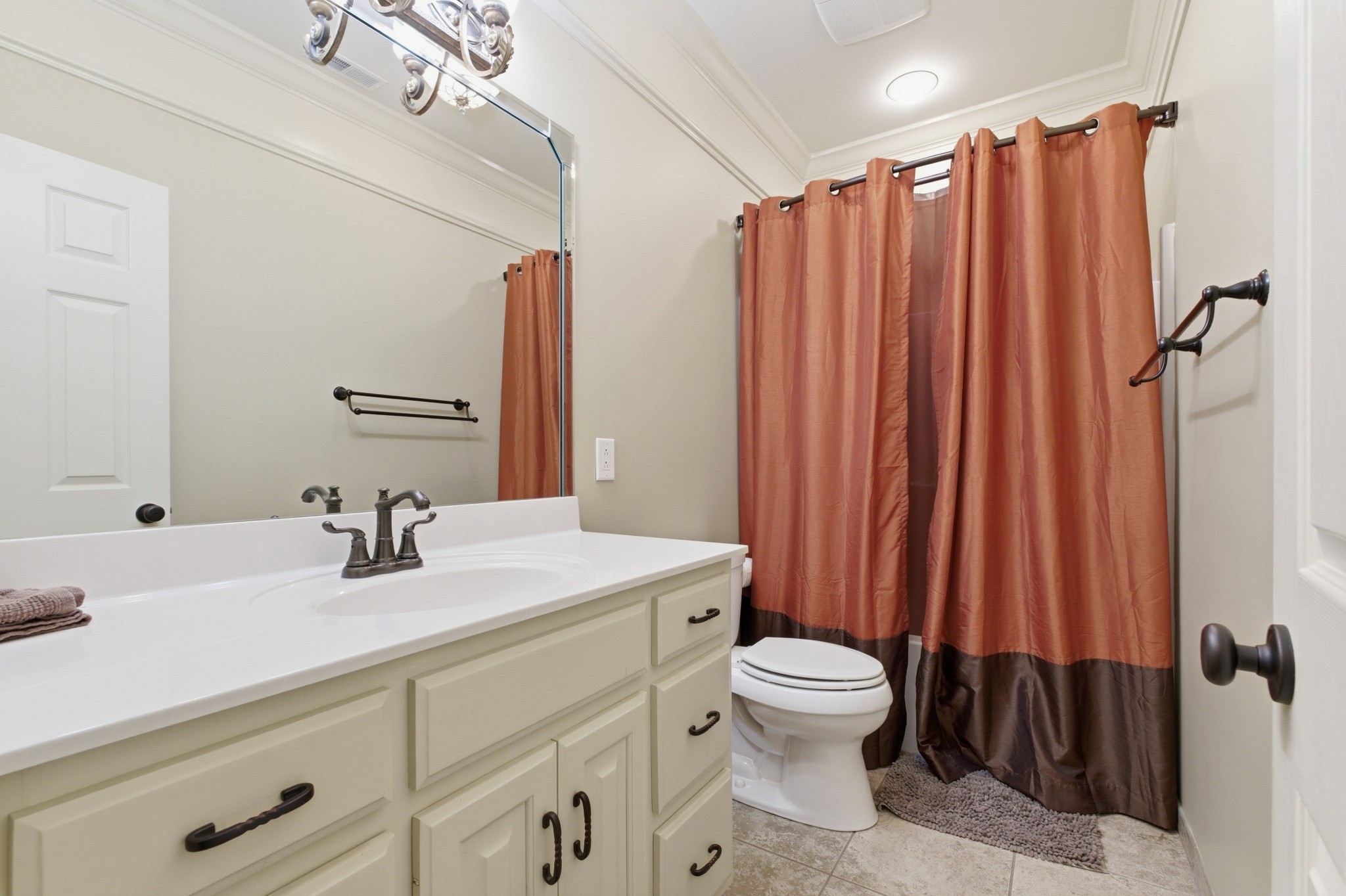 1605 Puryears Bend Road Hartsville, TN 37074 - Photo 34 of 63 a bathroom with a sink a toilet a mirror and shower curtain