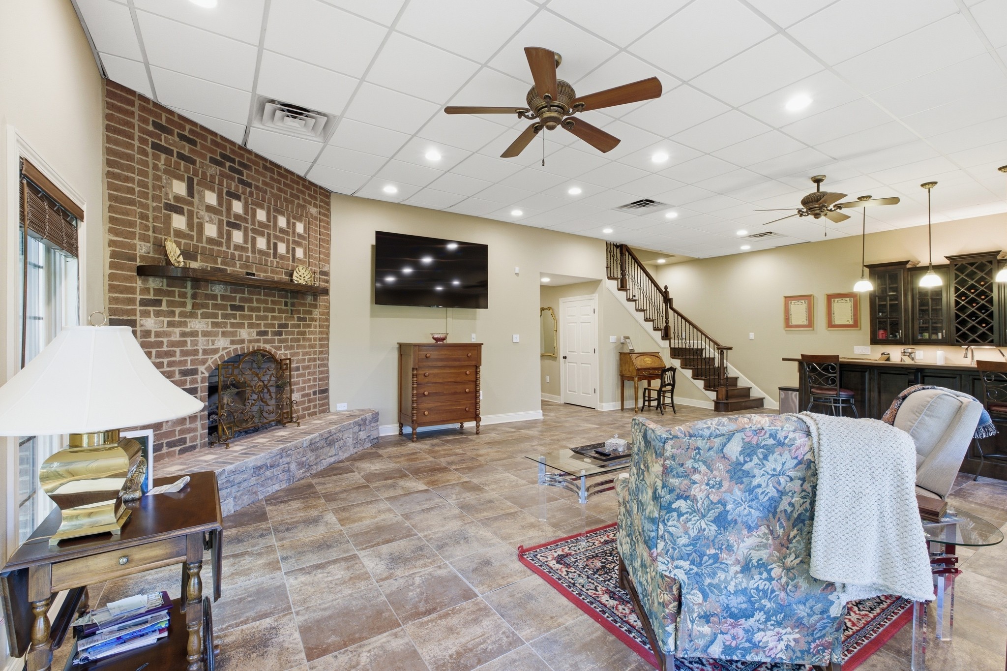 1605 Puryears Bend Road Hartsville, TN 37074 - Photo 42 of 63 a living room with furniture a fireplace and a flat screen tv