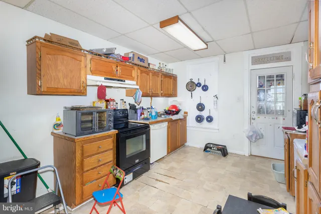 a kitchen that has a lot of cabinets and wooden floor