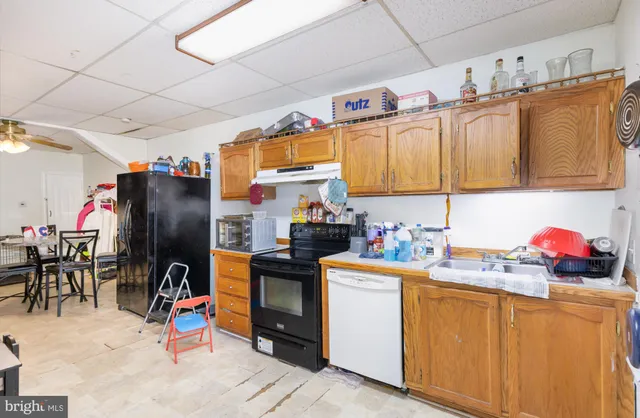 a kitchen with stainless steel appliances granite countertop a sink dishwasher and cabinets with wooden floor
