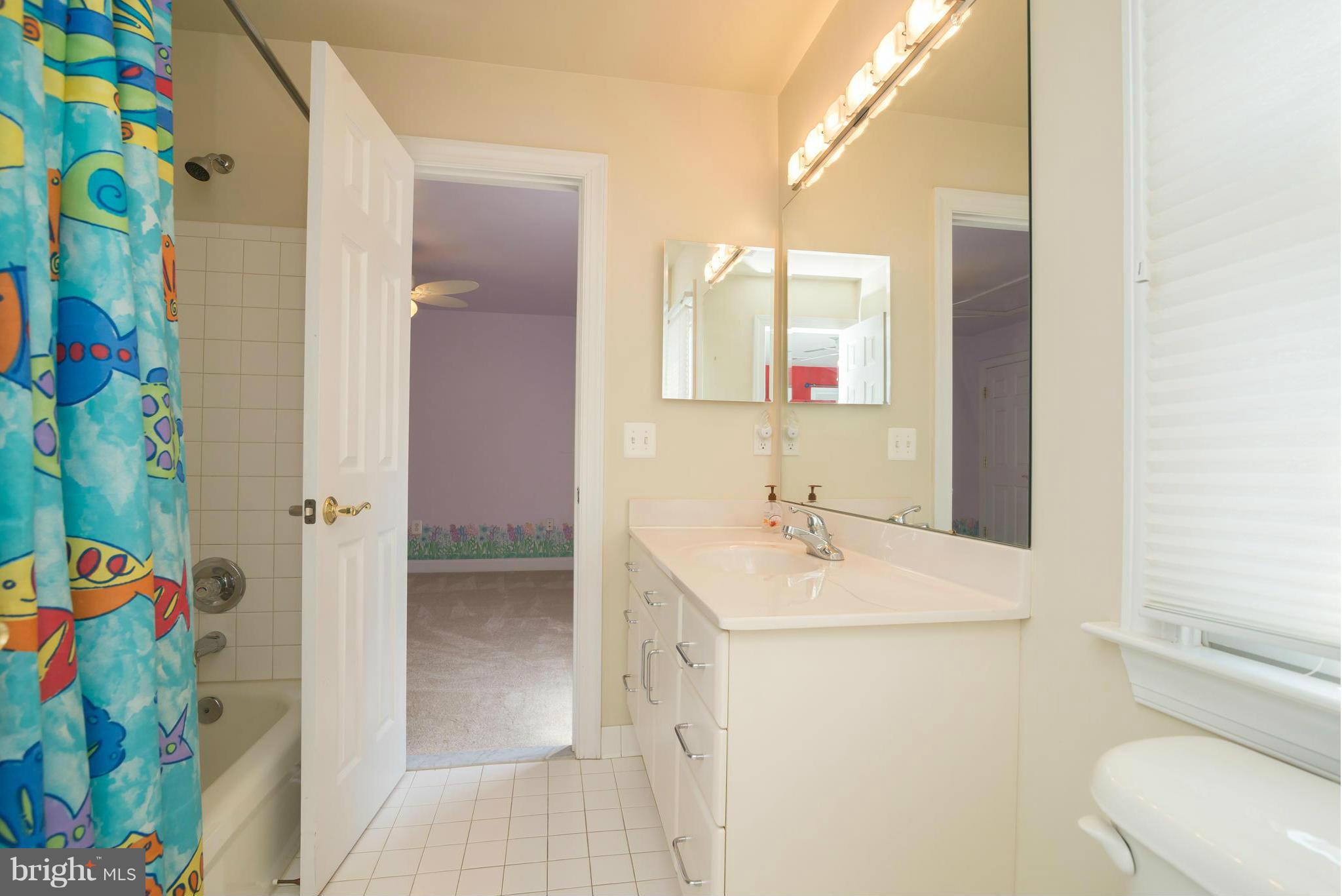 831 Woodside Parkway Silver Spring, MD 20910 - Photo 25 of 30 a bathroom with a sink a toilet and shower curtain